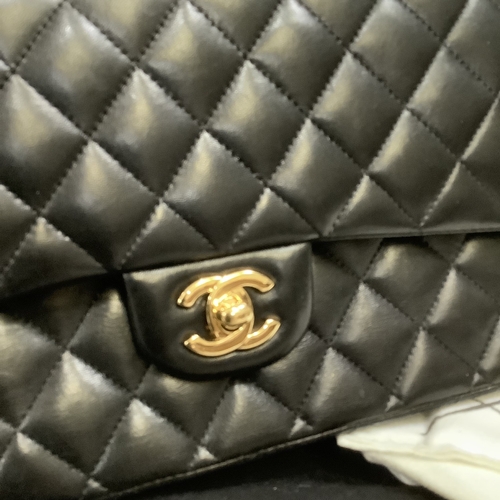 304 - A Chanel black quilted leather single flap bag with double chain strap, 25cm wide, together with aut... 