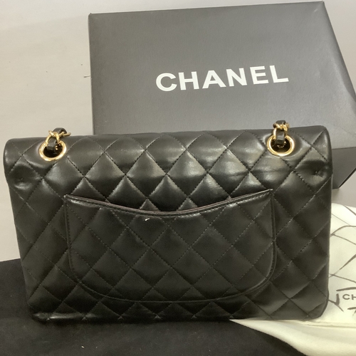 304 - A Chanel black quilted leather single flap bag with double chain strap, 25cm wide, together with aut... 
