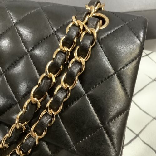 304 - A Chanel black quilted leather single flap bag with double chain strap, 25cm wide, together with aut... 