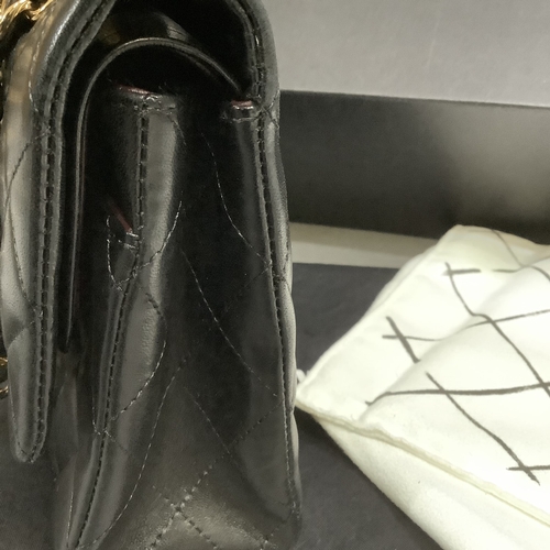 304 - A Chanel black quilted leather single flap bag with double chain strap, 25cm wide, together with aut... 