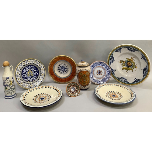69 - A collection of Italian tin glaze type ceramics including a charger, 30cm, two plates, 24.5cm, three... 