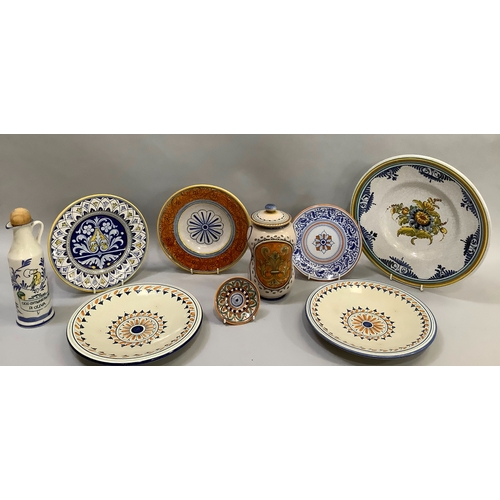 69 - A collection of Italian tin glaze type ceramics including a charger, 30cm, two plates, 24.5cm, three... 