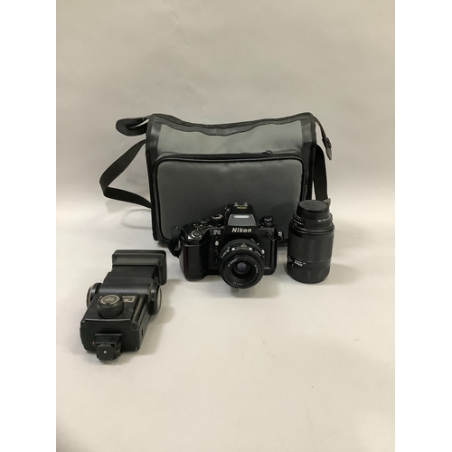 101 - A Nikon F4 camera with Nikkor 70mm lens, a Nikkor 70mm - 210mm zoom lens and a Vivitar zoom thyristo... 