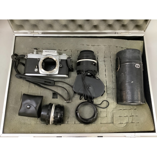 62 - A metal camera case containing a Nikkormat body, Nikon 85mm lens, Nikkor 200mm lens, a Nikon 50mm le... 
