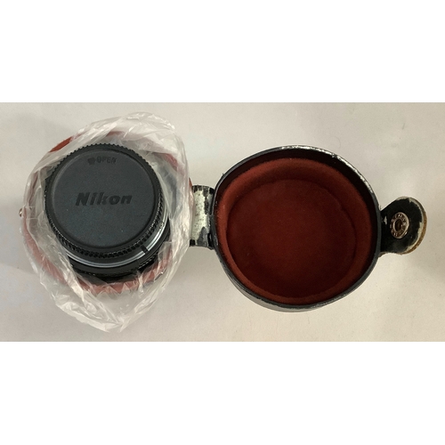 62 - A metal camera case containing a Nikkormat body, Nikon 85mm lens, Nikkor 200mm lens, a Nikon 50mm le... 