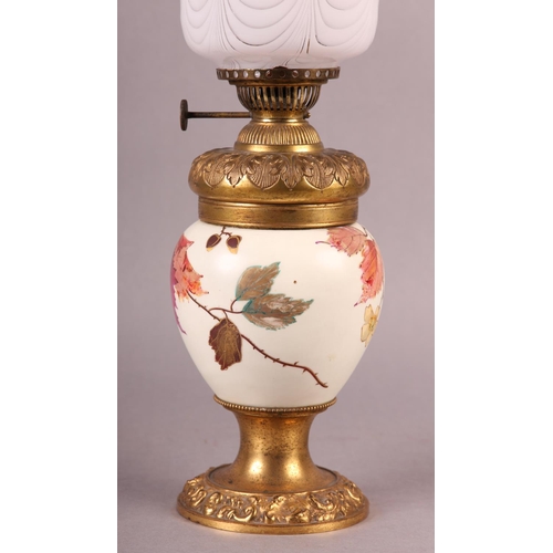 24 - A VICTORIAN GILT METAL AND CERAMIC OIL LAMP, the body painted and gilt with sprays of blossom and be... 