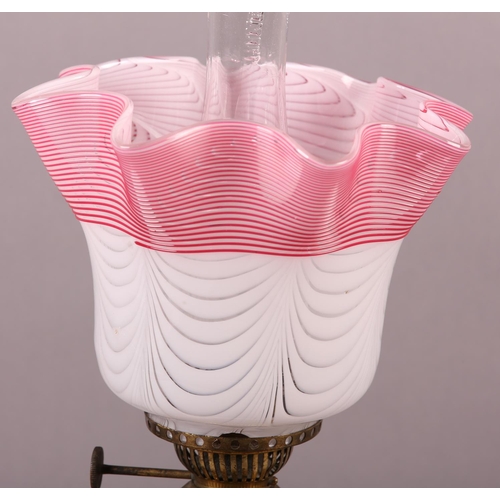 24 - A VICTORIAN GILT METAL AND CERAMIC OIL LAMP, the body painted and gilt with sprays of blossom and be... 