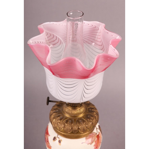 24 - A VICTORIAN GILT METAL AND CERAMIC OIL LAMP, the body painted and gilt with sprays of blossom and be... 