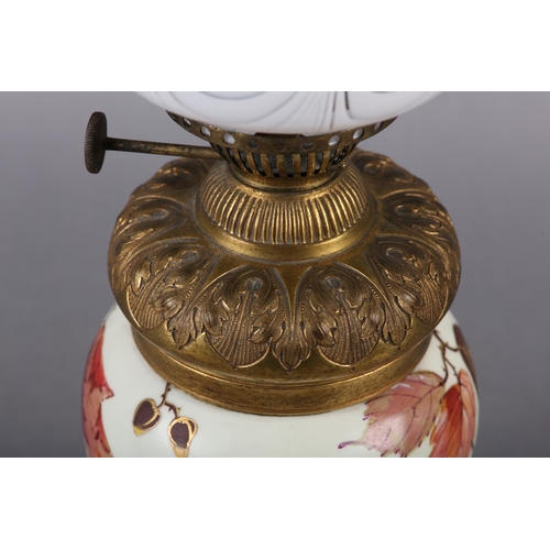 24 - A VICTORIAN GILT METAL AND CERAMIC OIL LAMP, the body painted and gilt with sprays of blossom and be... 