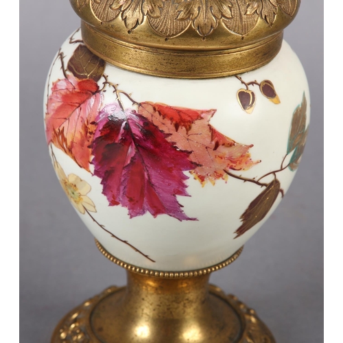 24 - A VICTORIAN GILT METAL AND CERAMIC OIL LAMP, the body painted and gilt with sprays of blossom and be... 
