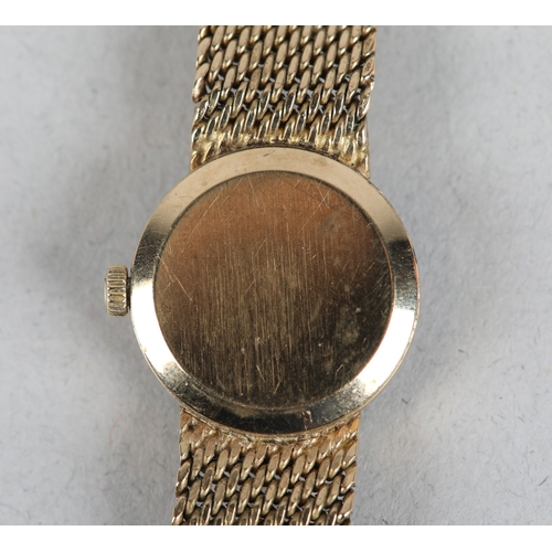 336 - AN OMEGA LADY'S MANUAL WRISTWATCH in 9ct gold on an integral textured Milanese bracelet in 9ct gold,... 