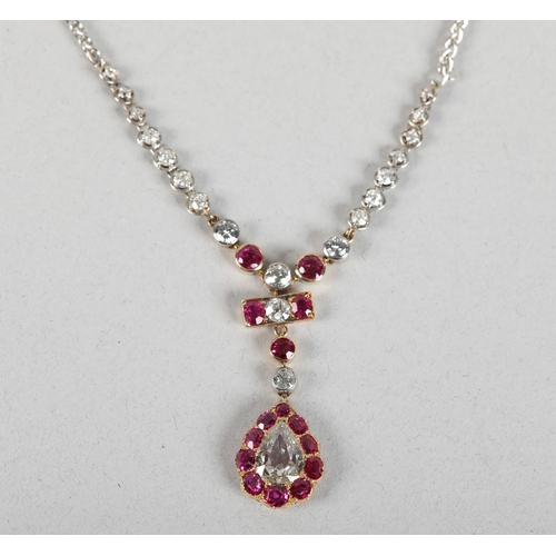 258 - A LATE 19TH CENTURY RUBY AND DIAMOND PENDANT, the principal pear shaped diamond set within a surroun... 