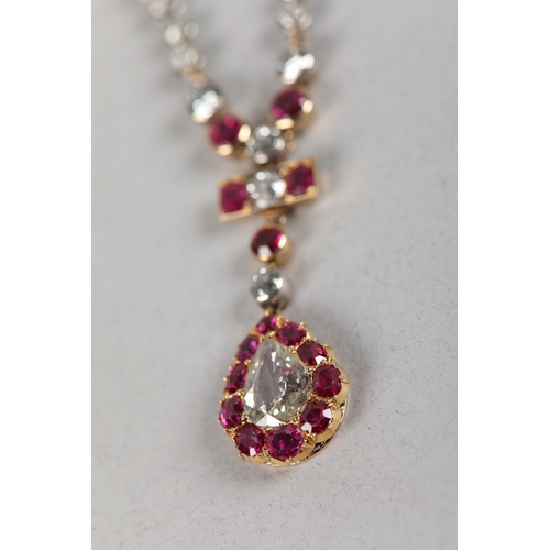 258 - A LATE 19TH CENTURY RUBY AND DIAMOND PENDANT, the principal pear shaped diamond set within a surroun... 