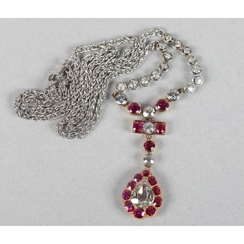 258 - A LATE 19TH CENTURY RUBY AND DIAMOND PENDANT, the principal pear shaped diamond set within a surroun... 