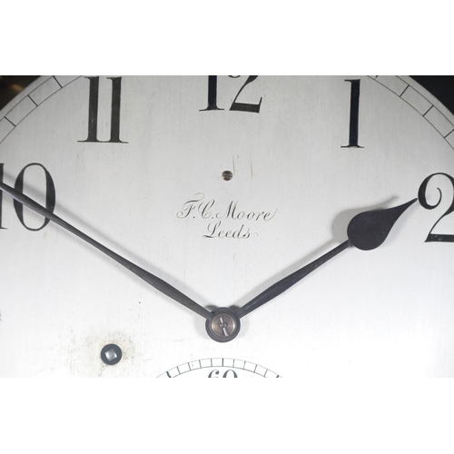 69 - AN EARLY 20TH CENTURY WALNUT AND GLAZED REGULATOR, signed F. C. Moore of Leeds, having a silvered di... 