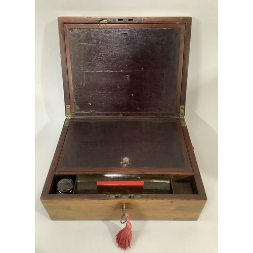 34 - A 19TH CENTURY MAHOGANY AND BRASS BOUND WRITING SLOPE, with vacant brass cartouche to the lid and si... 