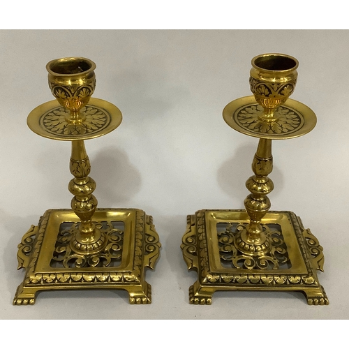 43 - A Victorian brass chamber stick with pierced handle of square outline with rounded corners and beade... 