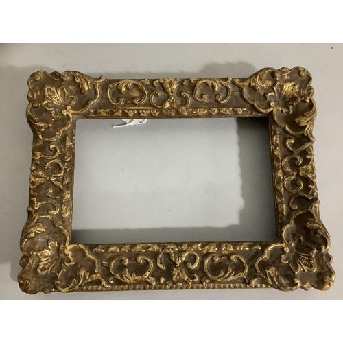 29 - A gilt picture frame moulded with leaf scrolls, 21cm x 28cm, the aperture with slip 13.5cm x 21cm, t... 