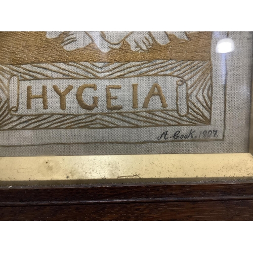 34 - A pair of needlework panels each depicting a female from mythology including Ceres and Hygeia in bro... 