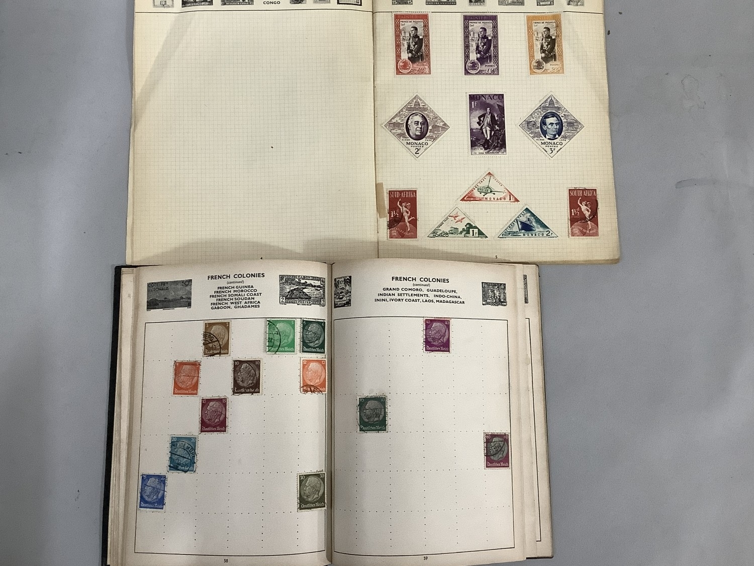 A quantity of loose world stamps used on paper together with four stamp ...