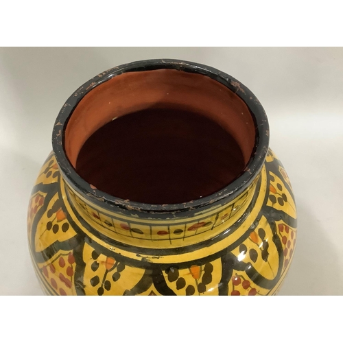 23 - A Safi pottery vase, the deep ochre ground painted in black, terracotta and orange with bands of loz... 
