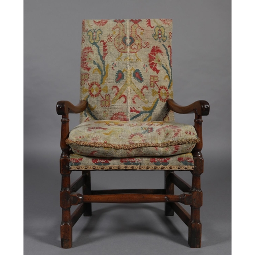 272 - A LATE 17TH CENTURY YEW-WOOD OPEN ARMCHAIR, the high back and cushioned seat upholstered in rug fabr... 