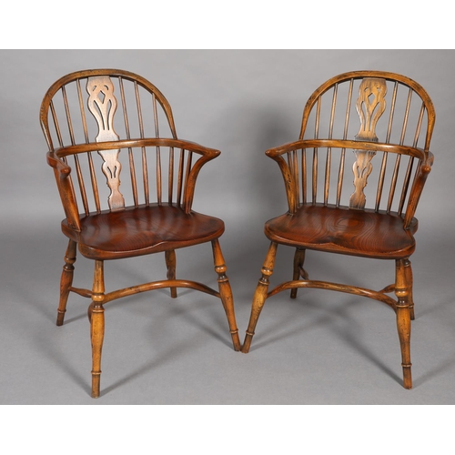 283 - A PAIR OF LOW BACK ELM WINDSOR ARMCHAIRS BY BATHEASTON, railed backs, shepherd's crook arm uprights,... 
