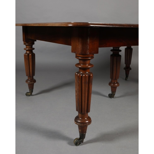 285 - A VICTORIAN MAHOGANY EXTENDING DINING TABLE, with five leaves, on five reeded and turned legs with b... 