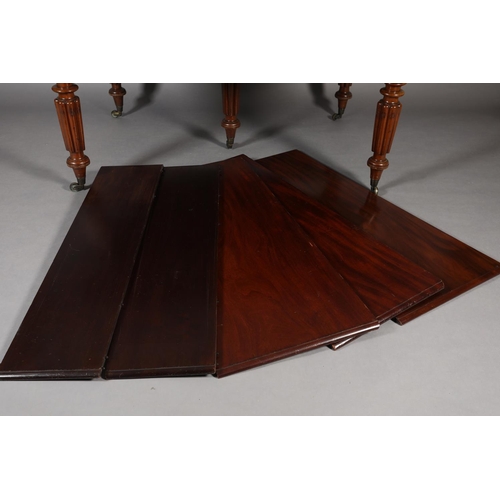 285 - A VICTORIAN MAHOGANY EXTENDING DINING TABLE, with five leaves, on five reeded and turned legs with b... 