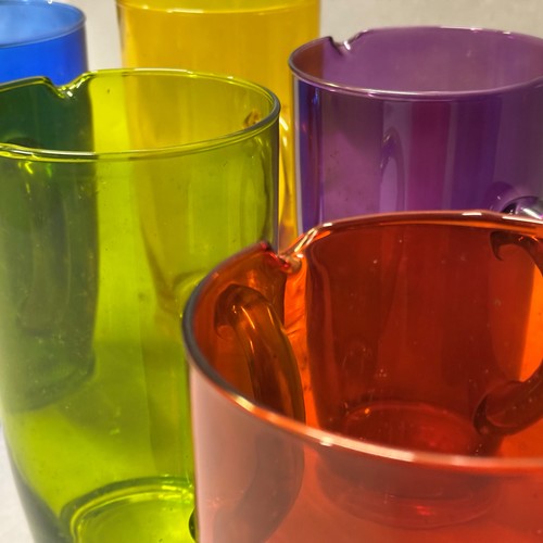 56 - A set of six 'Stone the Crows!' glass pitchers in six colour ways, 21cm high (6) Ref: 561608