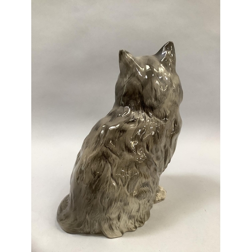 24 - A Beswick model of a cat sitting, stamped and impressed number 1867, 21cm high