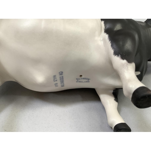 31 - A Beswick Friesian cow 'Champion Coddington Hiltbar', printed mark and title, 12.5cm, together with ... 