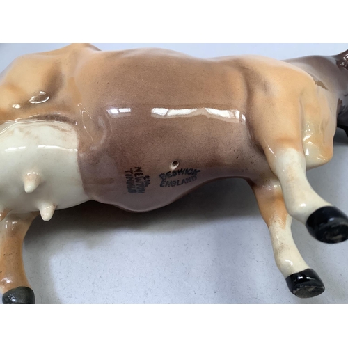31 - A Beswick Friesian cow 'Champion Coddington Hiltbar', printed mark and title, 12.5cm, together with ... 