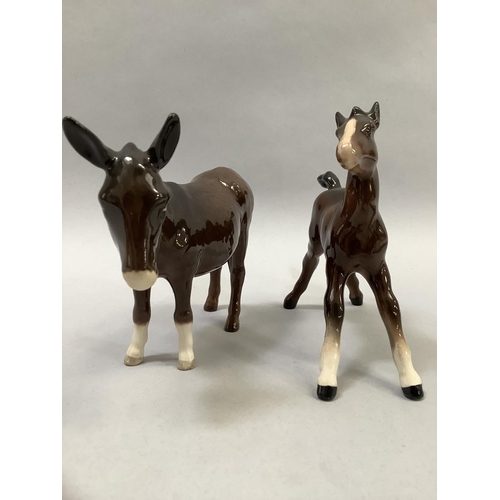 33 - A Beswick model of a donkey, a calf, a Collie dog, and a Jack Russell, the donkey, 11cm high, and a ... 