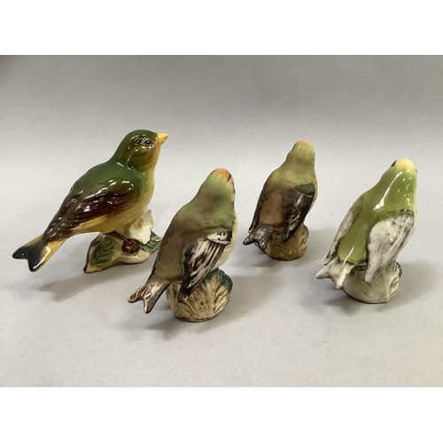 35 - Four Beswick birds including Greenfinch 2105, and three Goldcrest 2415 (one with chip to beak), the ... 