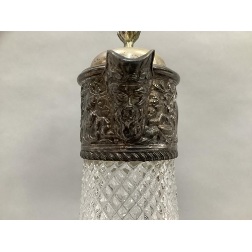 46 - A plate mounted cut glass claret jug with face mask spout and dragon handle, 30.5cm high