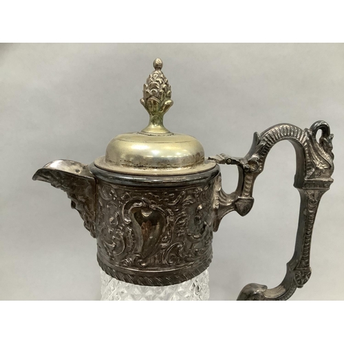 46 - A plate mounted cut glass claret jug with face mask spout and dragon handle, 30.5cm high