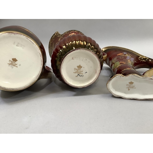 51 - Three Crown Devon Fielding's Rouge Royale lustre jugs, two of pagoda or temple garden pattern, the o... 