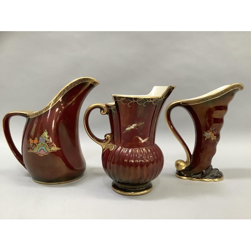 51 - Three Crown Devon Fielding's Rouge Royale lustre jugs, two of pagoda or temple garden pattern, the o... 