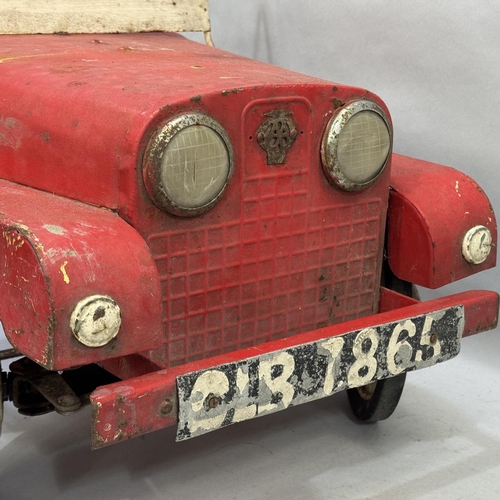 1 - A mid-century Tri-ang pressed steel Land Rover pedal car with fold down windscreen and battery-power... 