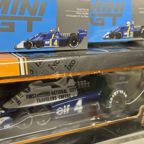 28 - An IXO die-cast scale model of a 1977 Tyrrell P34, a Mini GT die-cast scale model of the 1976 Tyrrel... 