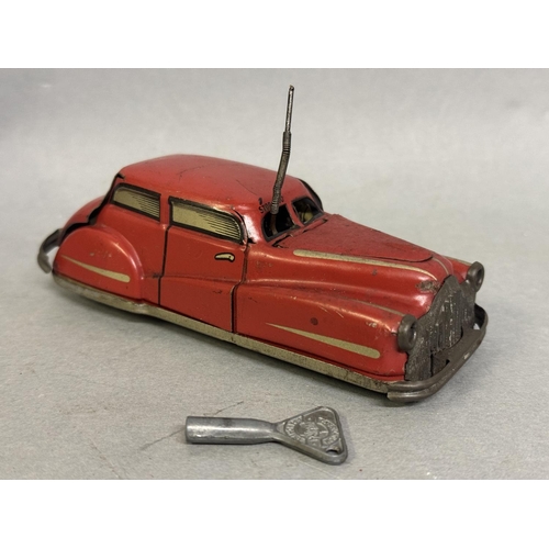 8 - A French Joustra clockwork car, in working order complete with original key. Car moves off, stops, o... 