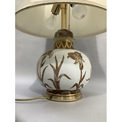 59 - A white ceramic table lamp of compressed globular form overlaid with marble effect flowers and grass... 