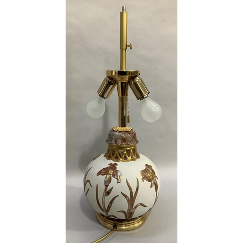 59 - A white ceramic table lamp of compressed globular form overlaid with marble effect flowers and grass... 