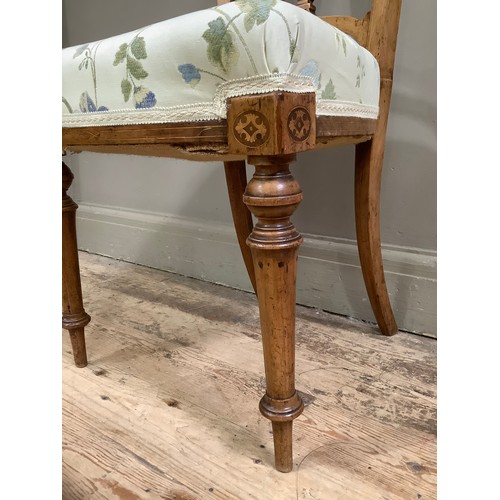 56 - A Victorian parlour chair with inlaid frame and upholstered seat on turned legs