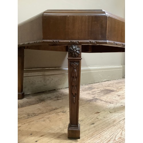 58 - A mahogany irregular octagonal low set occasional table on square tapered legs carved in relief with... 