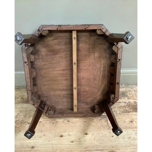 58 - A mahogany irregular octagonal low set occasional table on square tapered legs carved in relief with... 