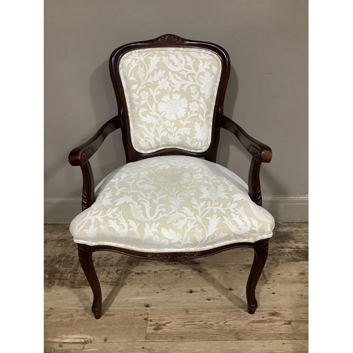 57 - A reproduction mahogany finished open arm chair with ivory and pale sand floral upholstery panel to ... 