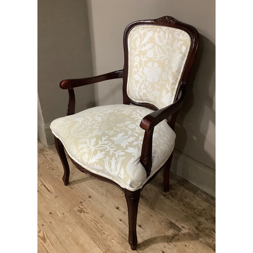 57 - A reproduction mahogany finished open arm chair with ivory and pale sand floral upholstery panel to ... 