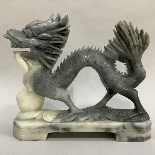 10 - A Chinese soapstone carving of a dragon with pearl, 20.5cm long x 18cm high